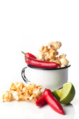 Detail of gourmet pepper, lemon, caramel popcorn over white background. Rustic utensils