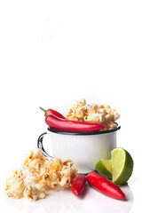Detail of gourmet pepper, lemon, caramel popcorn over white background. Rustic utensils