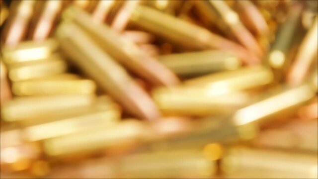 Focusing over pile of golden rifle ammunition