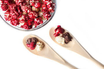 Rustic colored cups of Chocolate, Strawberry and Cream Gourmet Popcorn over white background.