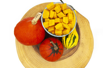 Fresh orange pumpkin whole and sliced â€‹â€‹on wood isolated on white background top view