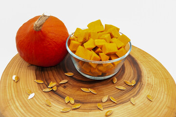 Fresh orange pumpkin whole and sliced ​​on wood isolated on white background top view