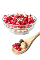 Rustic colored cups of Chocolate, Strawberry and Cream Gourmet Popcorn over white background.