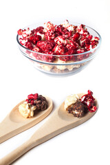 Rustic colored cups of Chocolate, Strawberry and Cream Gourmet Popcorn over white background.
