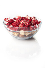 Rustic colored cups of Chocolate, Strawberry and Cream Gourmet Popcorn over white background.