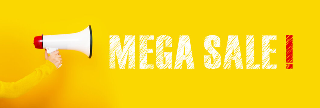 megaphone in hand on a yellow background, concept mega sale, panoramic image