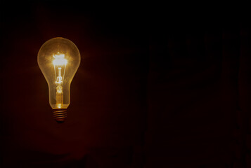 glowing light bulb against dark background
