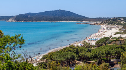 Fototapeta na wymiar Aerial panoramic view of the beach and sea with azure turquoise crystal clear water, mountains in the background, in Villasimius, Sardinia,Italy. Holidays, the best beaches in Sardinia.