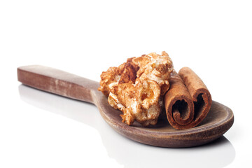 Amazing view of gourmet cinnamon and coffee popcorn with rustic utensils over a white background.