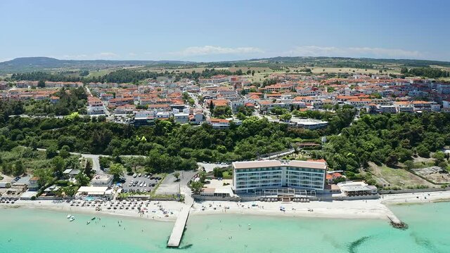 Drone zoom shot from waterfront to the most popular village in Halkidiki- Kallithea. It is located in the first peninsula of Halkidiki, Kassandra. 