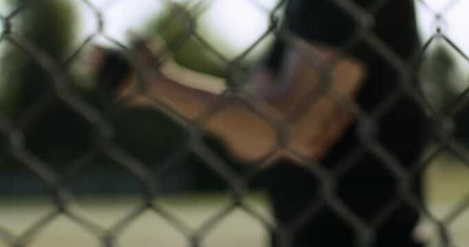 Sports stretching in the field. Baseball pitcher. Slow-motion pitcher stretching before the game. Preparing for competition. Shot in 4k.