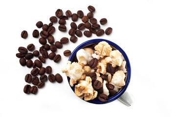 Amazing view of gourmet cinnamon and coffee popcorn with rustic utensils over a white background.