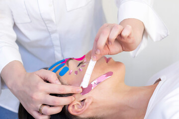 Face taping, close-up of a girls face with cosmetological anti-wrinkle tape. Face aesthetic taping....