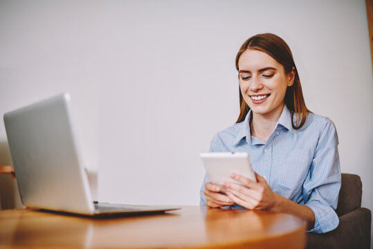 Serious young female received message on gadget and checking notification