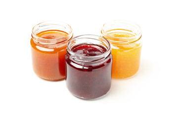 Glass jars with jam isolated on white background