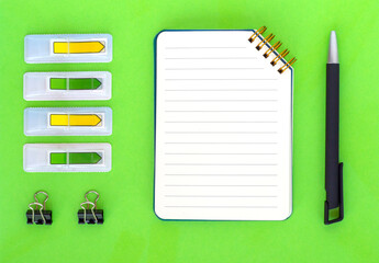 Flat lay with office or school stationery and supplies on bright green background. Top view, copy space. Back to school concept.