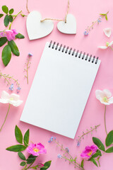 Mockup Flowers on pink background with notebook