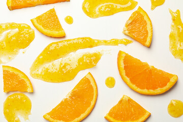 Composition with orange slices and jam on white background