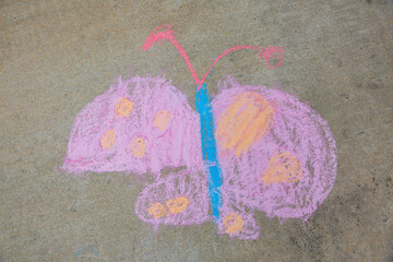 Butterfly drawn by a child using sidewalk chalk