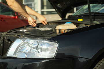 Man fixing engine. Car inspection. Work of mechanic