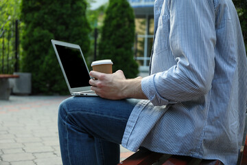 Fototapeta premium Young student working in a laptop and drinking coffee