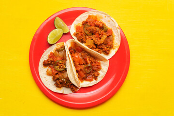 Mexican chorizo tacos on yellow background