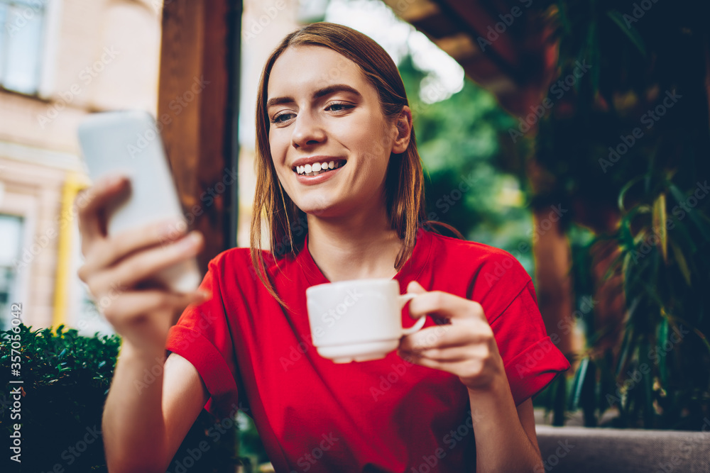 Poster half length portrait of positive blogger updating multimedia