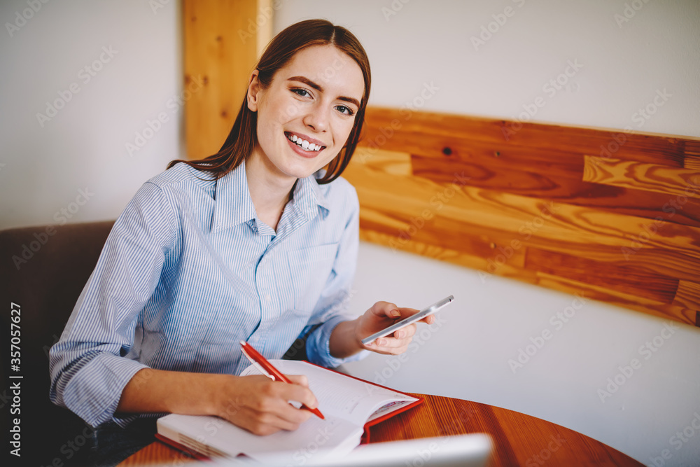 Poster happy student studying and chatting in break using mobile phone