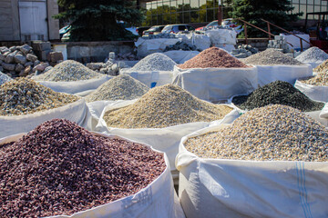 decorative river stones in a big bag outside on the street