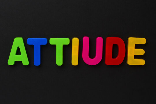 Text made in multicolored magnetic letters. ATTIUDE. Black