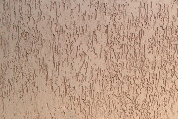 textured plasters pale pink color on the wall