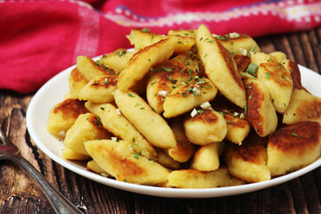 Polish dish kopytka served at the table	