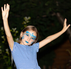 Girl with blue eyes and face painting, aqua mask