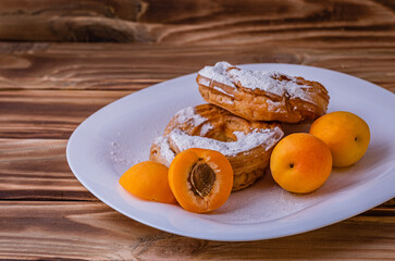 Ruffin custard ring with cottage cheese cream and apricots on a plate. Great dessert for Breakfast.