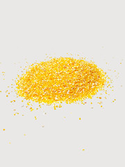 Slide of yellow corn or maize grits on a white background side view