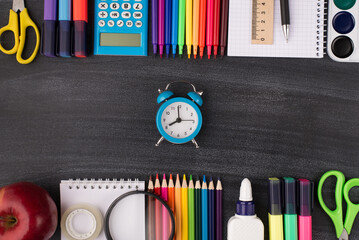 Time for school concept. Top above overhead view photo of clock in center and colorful stationery...