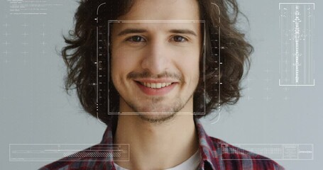 Close up of young guy with identification of biometric. Facial recognition of man. Male scanning of face features. Futuristic 3D identificating. Portrait on gray wall background. - Powered by Adobe