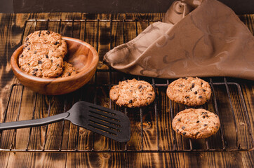 home cookies with pieces of chocolate on a wooden background/home cookies with pieces of chocolate on a wooden background with a hot blade
