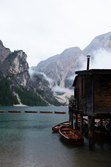photo of lago di braies lake, mountains, boats and green forest