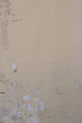 Old grungy concrete wall with peeling paint