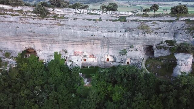 Aerial view of Saint Bernabe Ancient Heremitage in a cave in Ojo Guarena, Burgos, Spain. High quality 4k footage