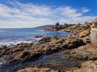 beautiful rocky coast, azure water and blue sky in Sunny weather in Saint Aygulf, France
