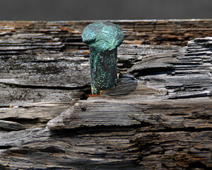 Metal spike  turned green from oxidation.