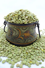 Green lentils in antique copper bowl
