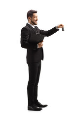 Full length profile shot of a businessman giving car keys