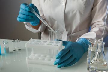 Fototapeta premium scientist hands doing chemical experiments in the laboratory close up