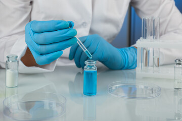 Fototapeta premium scientist hands doing chemical experiments in the laboratory close up