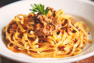 Tagliatelle wrapped in loin stumps flamed with red wine with a touch of cream and fine herbs.