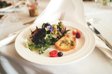 Vegetarian menu. White plate with fresh vegetable laying on wooden table. Celebration, party, birthday or wedding concept.