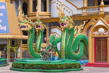 Fototapeta premium KRABI, THAILAND - 21 MARCH 2018: Four green dragons guarding the entrance to the Tiger Cave Temple.
